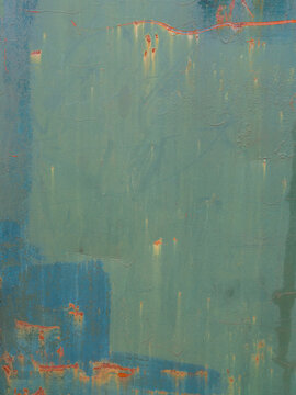 peeling multi-colored paint on a distressed wall