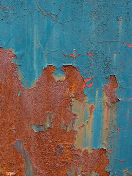 peeling multi-colored paint over rusty metal