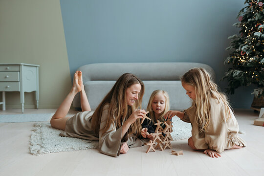 Mother and children plays game.