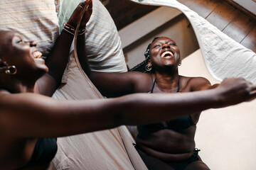Black woman in underwear laughing