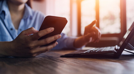 businesswoman hand working with laptop computer, tablet and smart phone in modern office with virtual icon diagram at modernoffice in morning light