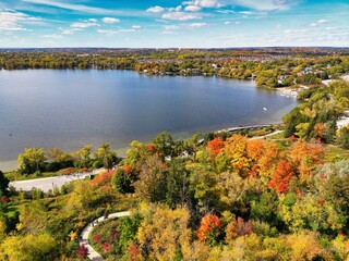 Fototapeta na wymiar Aerial view of lake and forest in autumn season at Lake Wilcox. Wilcox is a kettle lake in the Oak Ridges neighbourhood of Richmond Hill, Ontario, Canada.
