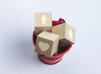 Male and female figures icon on wooden cube, heart shape, relationship concept.