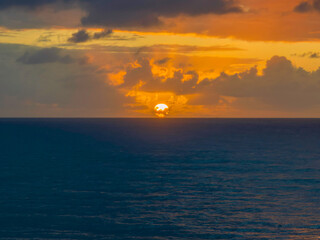 Drizzly moody sunrise seascape with cloud filled sky