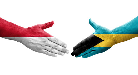 Handshake between Bahamas and Monaco flags painted on hands, isolated transparent image.