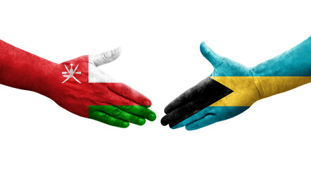 Handshake between Bahamas and Oman flags painted on hands, isolated transparent image.