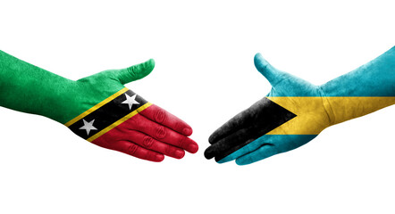 Handshake between Bahamas and Saint Kitts and Nevis flags painted on hands, isolated transparent image.