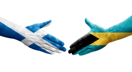 Foto op Plexiglas Handshake between Bahamas and Scotland flags painted on hands, isolated transparent image. © prehistorik