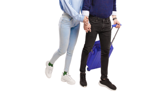 Male and female traveler holding hands happily walking with blue suitcase with transparent background