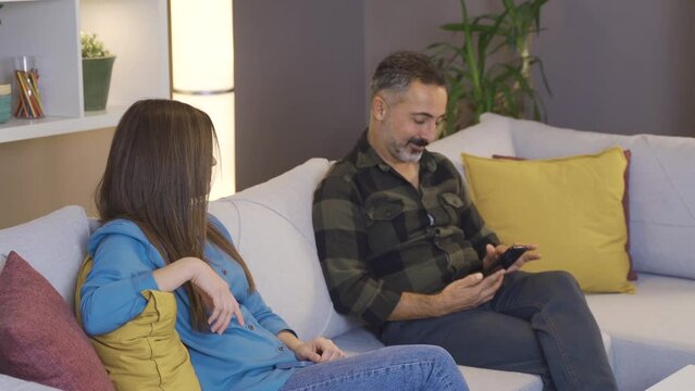 Family problems. The woman does not trust her husband. Confidence issue.
The woman suspects her husband, takes the phone from her hand, checks it and gives it back.
