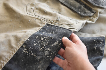 Dirty clothes with cement stains. Photo can be used for the concept of how to remove cement stains...
