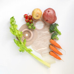 Two piece ostomy appliance including flange and pouch surrounded by varias fruit