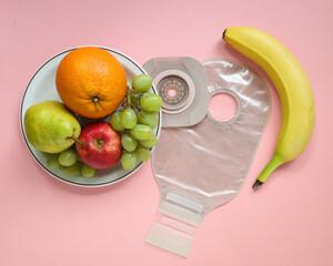 Two piece ostomy appliance including flange, pouch with a side plate of fruit.