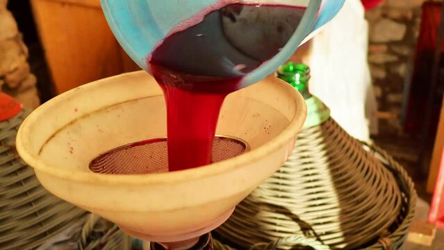 local senior farmer red wine filtering fining to finishing before bottling