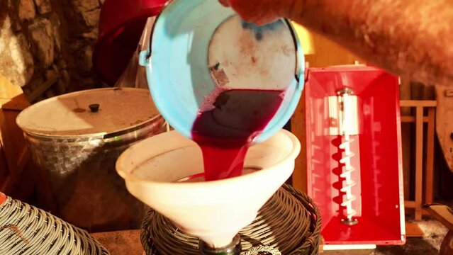 local senior farmer red wine filtering fining to finishing before bottling