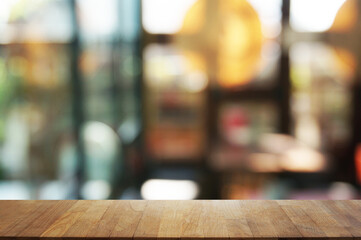 Empty dark wooden table in front of abstract blurred bokeh background of restaurant . can be used for display or montage your products.Mock up for space.