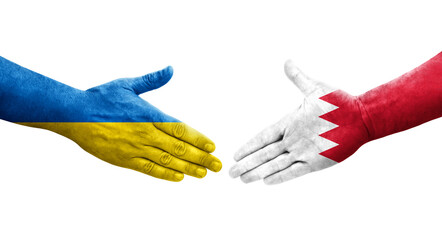 Handshake between Bahrain and Ukraine flags painted on hands, isolated transparent image.
