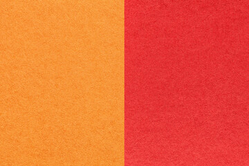 Fototapeta premium Texture of craft bright orange and red paper background, half two colors, macro. Structure of vintage ruby cardboard.
