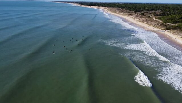 drone flies over the line-up of the les grenettes reef-break on the island of r&eacute; in the atlantic ocean, drone shot in sunny weather