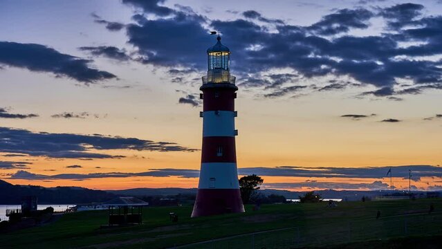 Plymouth sunset timelapse of the Hoe with Smeaton's Tower lighthouse. Devon, England, UK