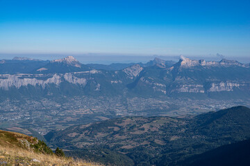 Obraz premium Valley with the city of Grenoble seen from the mountains of Chamrousse in summer in the Alps in France 