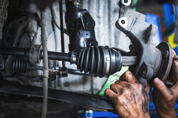 CV Axles replacement on a front wheel drive car. - obrazy, fototapety, plakaty