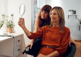 Hairstyle, hairdresser and woman with mirror happy with haircut in salon. Success, happiness and...