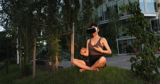 Beautiful girl doing yoga in the digital universe. Virtual reality. VR glasses.