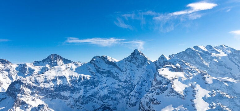 The beautiful view of snow-capped mountain peaks of  Swiss Mountain against the blue sky background