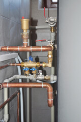Copper pipes heating system. House heating system copper pipes.  Copper pipes of solar water heater system in boiler room.
