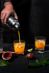 Marakuya coctail with shaker and man hand