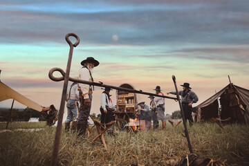 Cowboys group have outdoor campfire ,boiling hot water and coffee in morning travel avenger western...