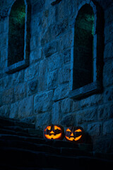 Halloween pumpkins jack p lantern in the yard of an old castle at night in the bright moonlight - obrazy, fototapety, plakaty