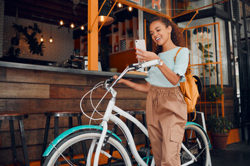 Obraz na płótnie Canvas Woman, happy and bike with phone at cafe on travel in city with bag. Black woman, smartphone and smile for communication, meme or social media on app with bicycle at coffee shop in San Francisco