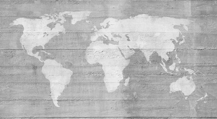 White world map painted on a gray concrete wall, the map is weathered and scratched. High...