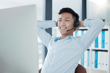 Asian man in call center office stretching, relax in easy working for customer support service...