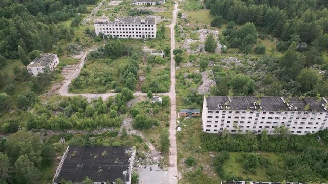 Irbene, Latvia - Aerial drone flight over the soviet ghost town Irbene with old and lost soviet buildings - a settlement for military officers and their families - 2022 bird view