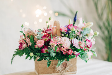 Beautiful pink flowers composition in the box close-up view. Festive decoration and background