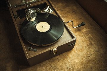 Vintage gramophone for playing records with a wind-up handle. Listen to music on a record.