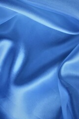 Beautiful light blue fabric, folded in soft folds. Silk, satin or satin.