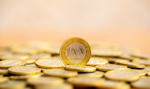 Coins of the state of Kazakhstan close-up. Kazakhstani coins of 200 and 100 tenge on a banknote. The concept of banking and inflation.