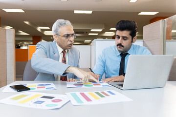 Man with old father using laptop while planning budget finance in office.