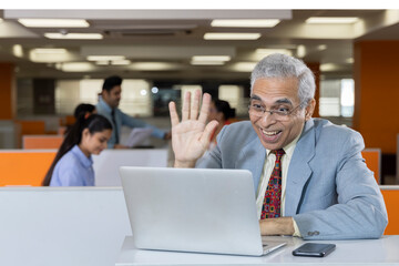 Video conferencing using laptop at office.
