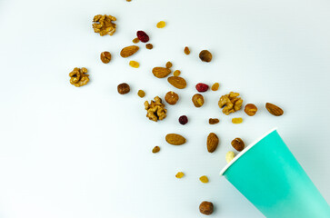 nuts are poured from a paper cup