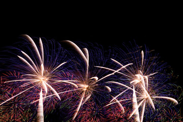 Close-up of colorful fireworks on a black background.