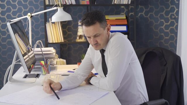 Thoughtful businessman on a project.
Businessman making progress on project is thinking.
