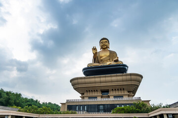 Close-up of the giant Buddha statue with the blue sky background