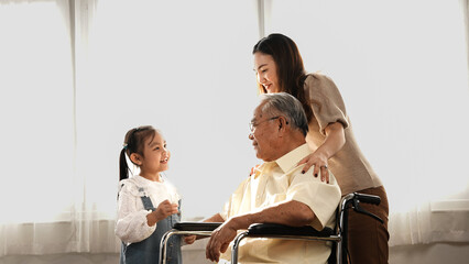 Happy Family Multi-generation Mother and daughter taking care of the senior grandfather in the...