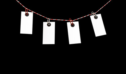 white notes hanging on a rope with paper clips on a black background