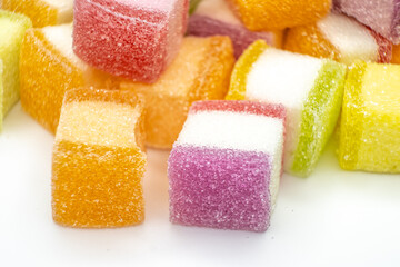 Colorful jelly candy mix white granulated sugar on white background